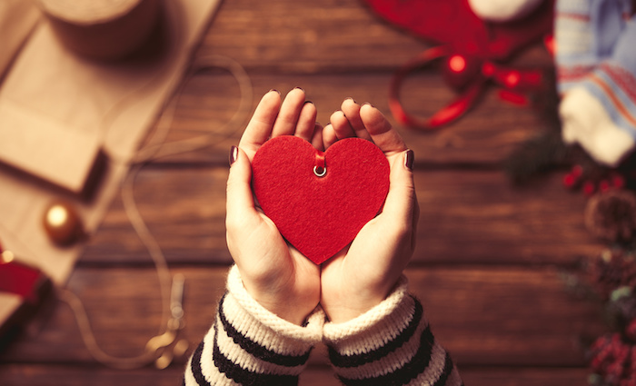 Woman holding a heart shape toy